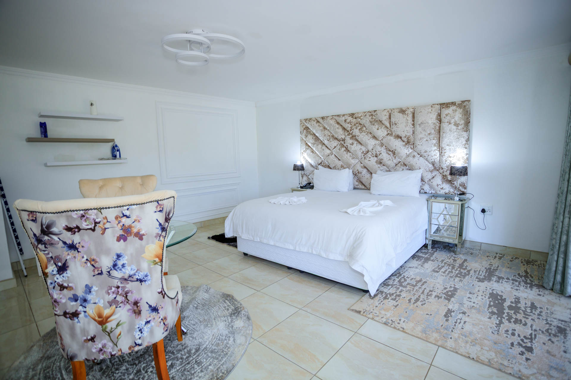 Deluxe Suite bedroom with comfortable bed and modern furnishings